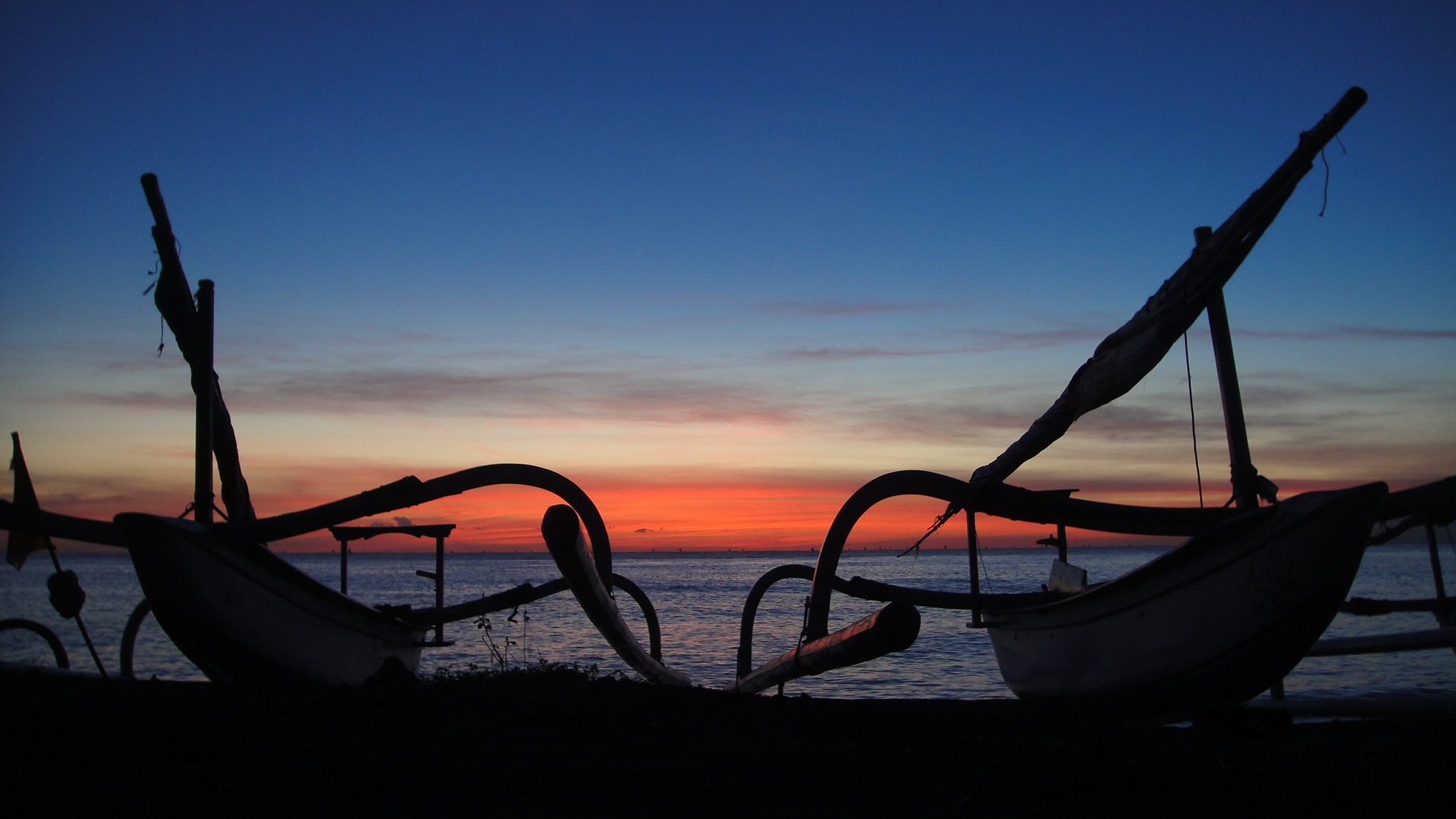 Outriggers at sunrise over the Lombok Straits